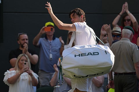 Taylor Fritz of the United States leaves the court after losing to Alexander Zverev of Germany in their quarter-final men's singles match at the Wimbledon Tennis Championships in London.