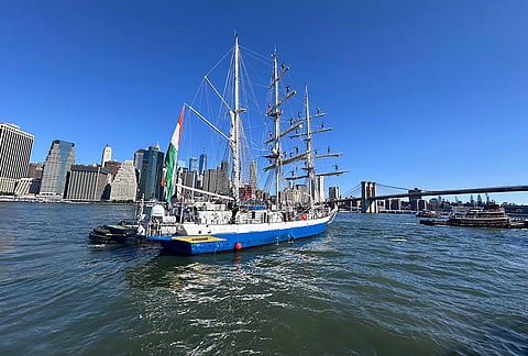 Indian Navy's sail training ship INS Sudarshini sails out of New York Harbour after participating in the International Naval Review 250 and Sail4th 250 celebrations, with the Brooklyn Bridge and Manhattan skyline in the background, in New York. 