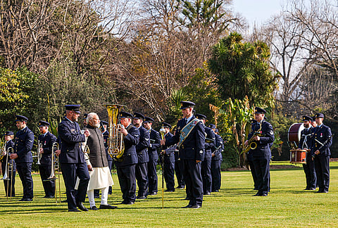 Prime Minister Narendra Modi interacts with members of the ceremonial military band after receiving a ceremonial welcome at Government House, in Melbourne, Australia. 