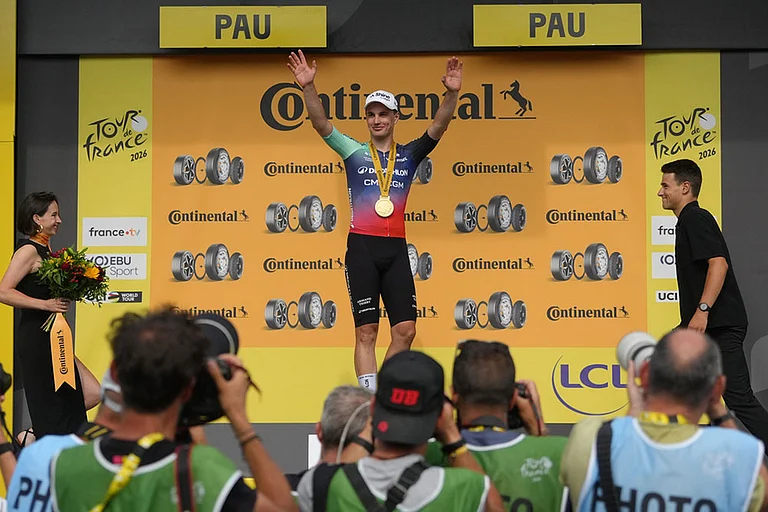 Netherland's Olav Kooij celebrates on the podium after winning the fifth stage of the Tour de France cycling race with start in Lannemezan and finish in Pau, France. - | Photo: AP/Thibault Camus