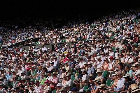 Spectators watch the women's singles semifinal match between Linda Noskova of the Czech Republic and Marta Kostyuk of Ukraine, at the Wimbledon Tennis Championships in London.