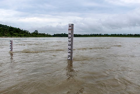 A water level gauge stands in the swollen Ganga River, which is flowing close to the warning mark following incessant monsoon rains, in Rishikesh.