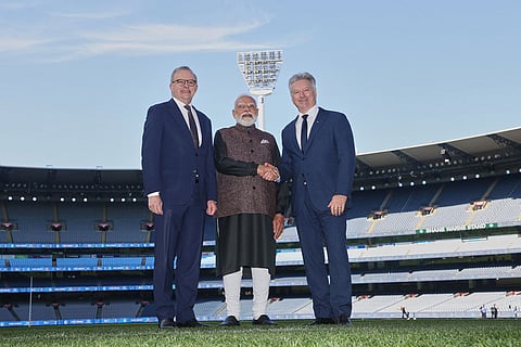 Indian Prime Minister Narendra Modi, center, shakes hands with former Australian cricket captain Steve Waugh, right, as Australian Prime Minister Anthony Albanese watches at the Melbourne Cricket Ground in Melbourne, Australia.