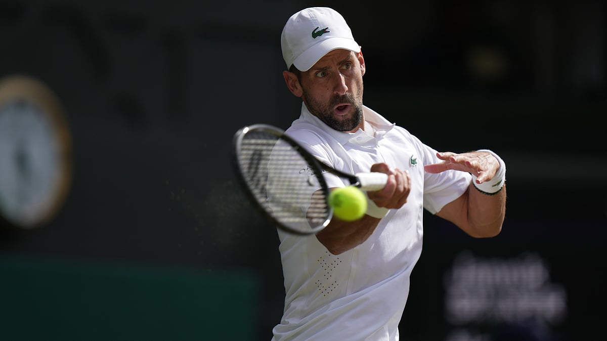 Novak Djokovic of Serbia returns the ball to Jannik Sinner of Italy in their men's singles semifinal match at the Wimbledon Tennis Championships in London, Friday, July 10, 2026. - (AP Photo/Brian Inganga)