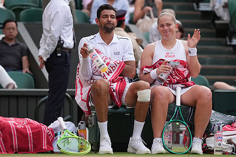 Jelena Ostapenko of Latvia and Marcelo Arevalo of El Salvador react during a changeover in their mixed doubles final match against Marc Polmans of Australia and Storm Hunter of Australia, at the Wimbledon Tennis Championships in London.