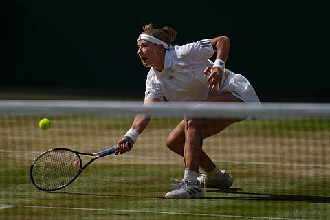 Karolina Muchova of the Czech Republic returns the ball to Coco Gauff of the United States in their semifinal women's singles match at the Wimbledon Tennis Championships in London