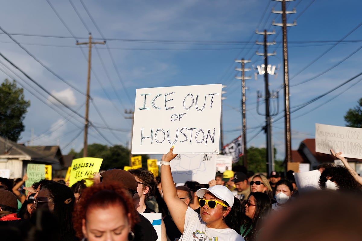 A woman holds a sign reading "ICE OUT OF HOUSTON" during a vigil for Lorenzo Salgado Araujo, a Mexican national fatally shot by a federal immigration agent a day prior, Wednesday, July 8, 2026, in Houston.  - (AP Photo/Mark Felix)