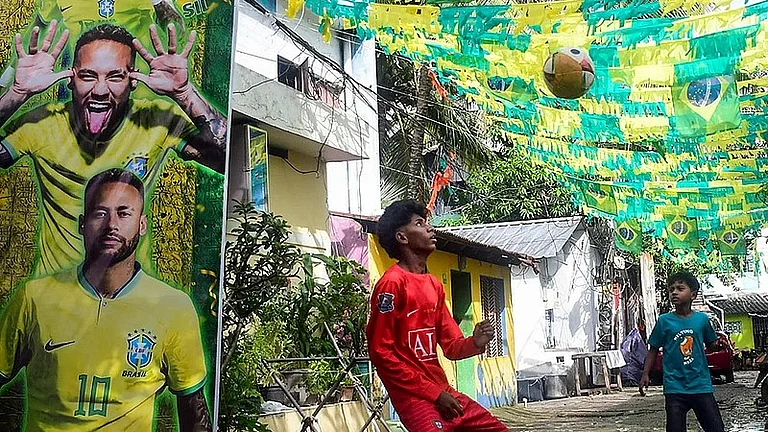 Young boys play football in a street decorated with Brazilian flags and a large poster of footballer Neymar Jr ahead of FIFA World Cup 2026, in Thiruvananthapuram. - Photo: PTI