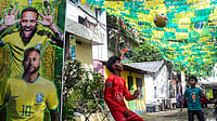 Photo: PTI : Young boys play football in a street decorated with Brazilian flags and a large poster of footballer Neymar Jr ahead of FIFA World Cup 2026, in Thiruvananthapuram.