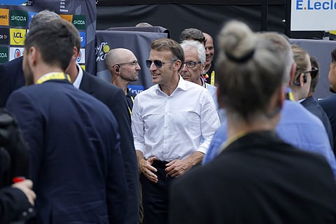 French President Emmanuel Macron, centre, walks after Stage 6 of the Tour de France, a 186.2 km (about 115,7 miles) route from Pau to Gavarnie-Gedre, in Gavarnie-Gedre, France.