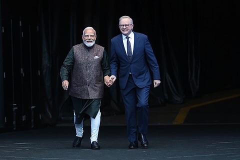 Indian Prime Minister Narendra Modi, left, and Australian Prime Minister Anthony Albanese walk out onto the field at the Melbourne Cricket Ground in Melbourne, Australia.
