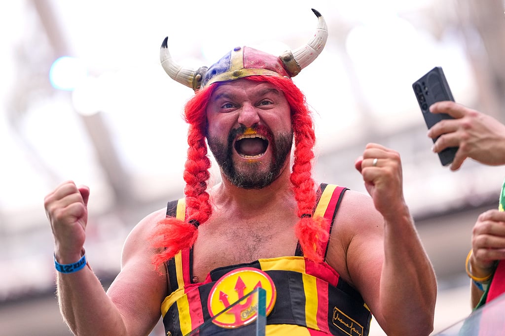 A fan cheers during warmups before the World Cup quarterfinal soccer match between Spain and Belgium in Inglewood