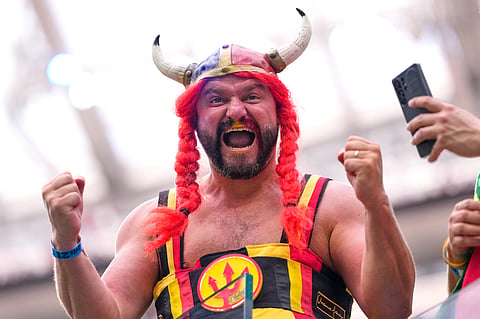 A fan cheers during warmups before the World Cup quarterfinal soccer match between Spain and Belgium in Inglewood