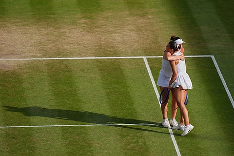Linda Noskova of Czech Republic, left embraces Marta Kostyuk of Ukraine after winning their women's singles semifinal match at the Wimbledon Tennis Championships in London.