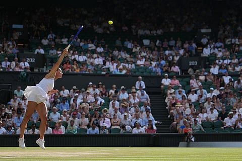 Marta Kostyuk of Ukraine serves against Linda Noskova of the Czech Republic in their semifinal women's singles match at the Wimbledon Tennis Championships in London.