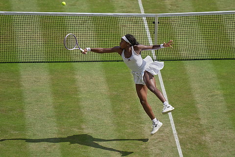 Coco Gauff of the United States leaps as she plays a return to Karolina Muchova of Czech Republic during their women's singles semifinal match at the Wimbledon Tennis Championships in London.