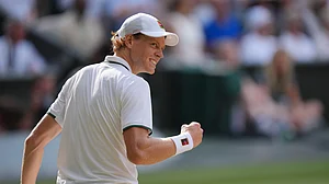 (AP Photo/Kin Cheung) : Jannik Sinner of Italy celebrates a point against Novak Djokovic of Serbia in their men's singles semifinal match at the Wimbledon Tennis Championships in London, Friday, July 10, 2026.