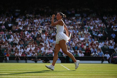 Marta Kostyuk of Ukraine celebrates a point against Linda Noskova of the Czech Republic in their semifinal women's singles match at the Wimbledon Tennis Championships in London.