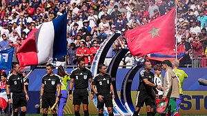 AP/Matt Slocum : Morocco's Achraf Hakimi, right greets the referee crew of referee Facundo Tello, center, assistant referees Juan Pablo Belatti and Gabriel Chade, fourth official Dario Herrera and reserve assistant referee Cristian Navarro, all five from Argentina, before the World Cup quarterfinal soccer match between France and Morocco in Foxborough
