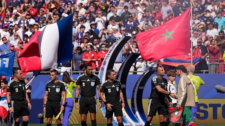 Morocco's Achraf Hakimi, right greets the referee crew of referee Facundo Tello, center, assistant referees Juan Pablo Belatti and Gabriel Chade, fourth official Dario Herrera and reserve assistant referee Cristian Navarro, all five from Argentina, before the World Cup quarterfinal soccer match between France and Morocco in Foxborough - AP/Matt Slocum
