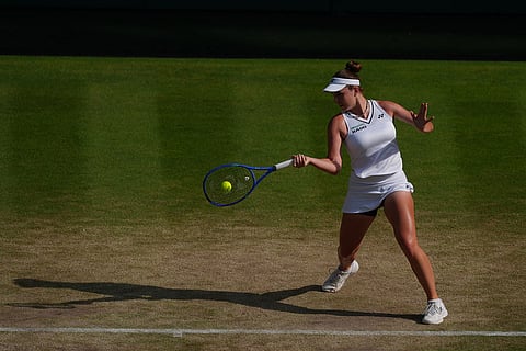 Linda Noskova of Czech Republic hits a return to Marta Kostyuk of Ukraine during their women's singles semifinal match at the Wimbledon Tennis Championships in London.