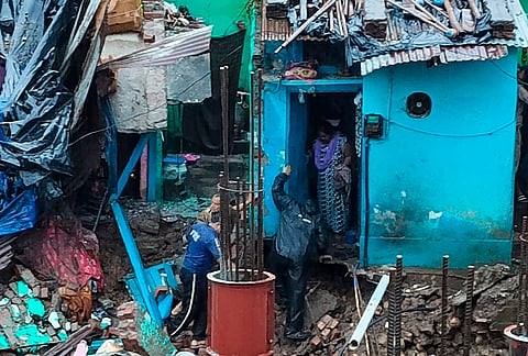 Police and Fire Service personnel rescue residents trapped inside a house damaged by heavy rainfall, in Haridwar.
