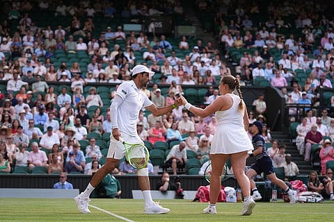 Jelena Ostapenko of Latvia and Marcelo Arevalo of El Salvador celebrate a point against Marc Polmans of Australia and Storm Hunter of Australia during their mixed doubles final match, at the Wimbledon Tennis Championships in London.
