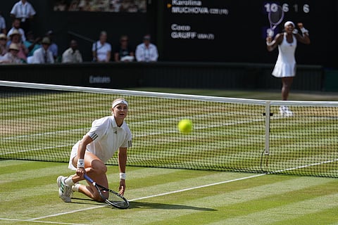 Karolina Muchova of the Czech Republic looks at the ball as Coco Gauff celebrates saving a match point against her in their semifinal women's singles match at the Wimbledon Tennis Championships in London.