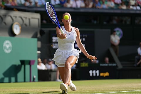 Marta Kostyuk of Ukraine returns the ball to Linda Noskova of the Czech Republic in their semifinal women's singles match at the Wimbledon Tennis Championships in London.