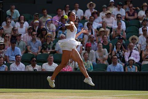 Marta Kostyuk of Ukraine returns the ball to Linda Noskova of the Czech Republic in their semifinal women's singles match at the Wimbledon Tennis Championships in London.