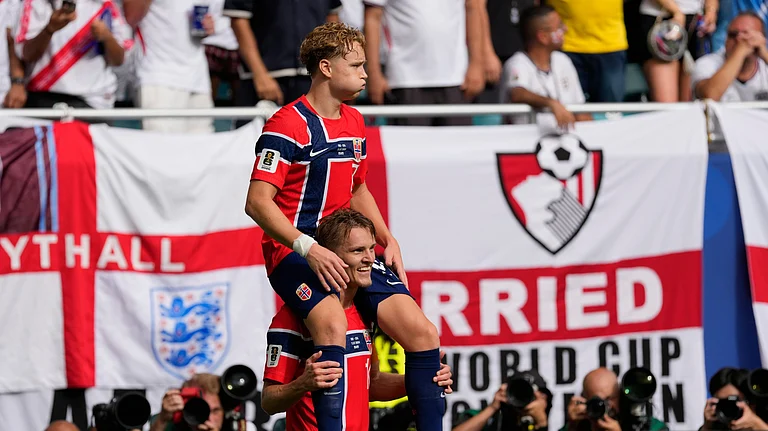 Norway's Andreas Schjelderup, top, celebrates scoring his side's opening goal with his teammate Martin Oedegaard during the World Cup quarterfinal soccer match between Norway and England in Miami Gardens, Fla., Saturday, July 11, 2026. - (AP Photo/Chris Carlson)