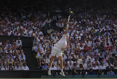 Jannik Sinner of Italy serves to Novak Djokovic of Serbia in their men's singles semifinal match at the Wimbledon Tennis Championships in London, Friday, July 10, 2026. 