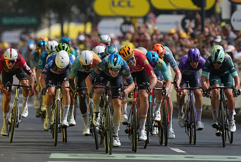 Belgium's Tim Merlier, center, sprints to the finish line to win the seventh stage of the Tour de France cycling race with start in Hagetmau and finish in Bordeaux, France, Friday, July 10, 2026.