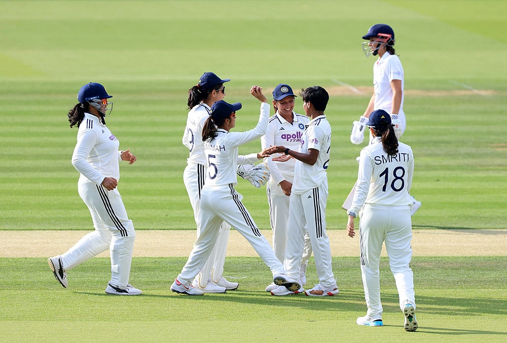 India's Kranti Gaud (second right) celebrates with her team mates after taking the wicket of England's Tammy Beaumont, background right, during day one of the first Women's Rothesay Test between India and England at Lord's Cricket Ground in London, Friday, July 10, 2026.  - | Photo: Nigel French/PA via AP
