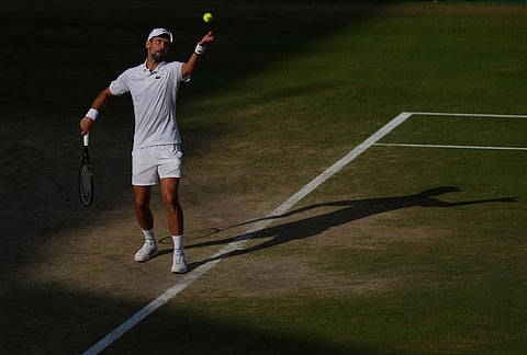 Novak Djokovic of Serbia serves to Jannik Sinner of Italy during their men's singles semifinal match at the Wimbledon Tennis Championships in London, Friday, July 10, 2026. 