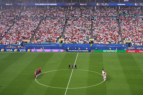 Players, officials and fans stand for a moment of silence for South Africa's Jayden Adams during the World Cup quarterfinal soccer match between Norway and England in Miami Gardens, Fla., Saturday, July 11, 2026.