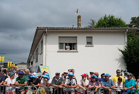 Spectators wait for the riders to pass during the seventh stage of the Tour de France cycling race over 175.1 kilometers (108.7 miles) with start in Hagetmau and finish in Bordeaux, France, Friday, July 10, 2026. 