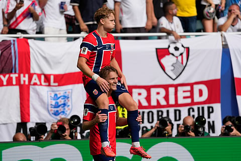 Norway's Andreas Schjelderup, top, celebrates scoring his side's opening goal with his teammate Martin Oedegaard during the World Cup quarterfinal soccer match between Norway and England in Miami Gardens, Fla., Saturday, July 11, 2026.