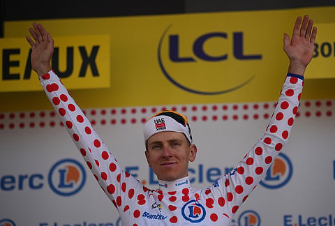 Slovenia's Tadej Pogacar, wearing the best climber's dotted jersey celebrates on the podium after the seventh stage of the Tour de France cycling race with start in Hagetmau and finish in Bordeaux, France, Friday, July 10, 2026.