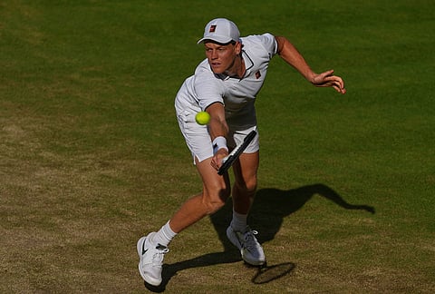 Jannik Sinner of Italy stretches to play a return to Novak Djokovic of Serbia during their men's singles semifinal match at the Wimbledon Tennis Championships in London, Friday, July 10, 2026. 