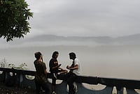 | Photo: PTI : People sit at a platform amid misty morning following rainfall, in Rishikesh, Uttarakhand.