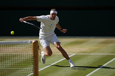Alexander Zverev of Germany returns the ball to Jannik Sinner of Italy in the men's singles final at Wimbledon Tennis Championships in London