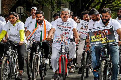 Karnataka Pradesh Congress Committee (KPCC) President BK Hariprasad along with Karnataka Pradesh Youth Congress President Manjunath Gowada and members take part in a cycle rally from KPCC office to Gandhi Statue as part of a demonstration to demand accountability and resignation of Union Education Minister Dharmendra Pradhan over NEET exam irregularities, in Bengaluru.