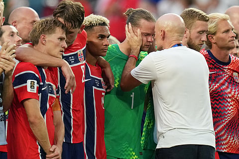 Norway goalkeeper Oerjan Nyland (1) is consoled by the coach Stale Solbakken after the World Cup quarterfinal soccer match against England in Miami Gardens, Fla., Saturday, July 11, 2026.
