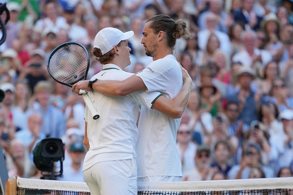 Jannik Sinner of Italy, left embraces Alexander Zverev of Germany at the net fter Sinner defeated Zverev in the mens singles final at Wimbledon Tennis Championships in London
