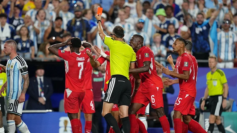 Referee Joao Pinheiro, of Portugal, gives a red card for Switzerland's Breel Embolo (7) during the World Cup quarterfinal soccer match between Argentina and Switzerland in Kansas City - Ed Zurga/AP Photo