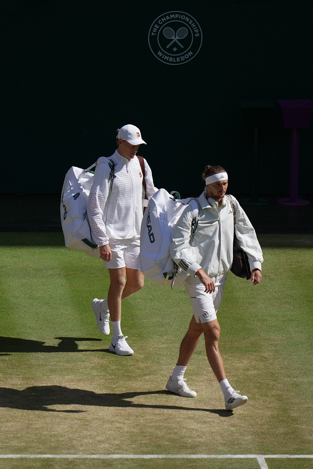 Jannik Sinner of Italy and Alexander Zverev of Germany, right, arrive on court to play the mens singles final at Wimbledon Tennis Championships in London