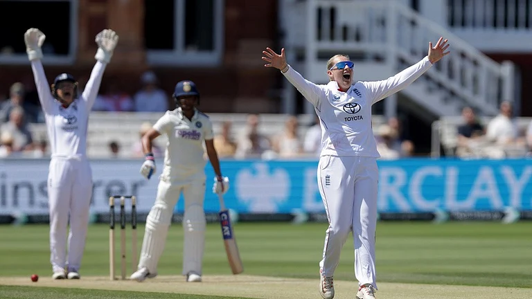 England's Sophie Ecclestone, foreground, appeals for the wicket of India's Harmanpreet Kaur, center, which was given after review, during day three of the first Women's Test match at Lord's cricket ground in London. - Steven Paston/AP Photo