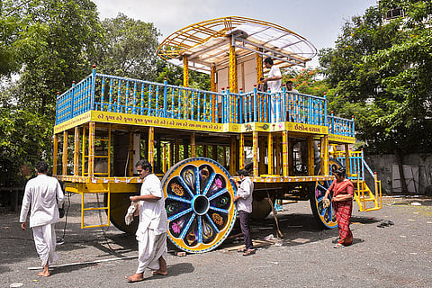 People clean the chariot of Lord Jagannath at the ISKCON temple ahead of the 'Rath Yatra' festival, in Surat, Gujarat.