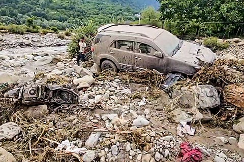 Vehicles lie damaged after a flash flood triggered by a cloudburst sweeps through the area, in Pahalgam, Anantnag district, Jammu and Kashmir.